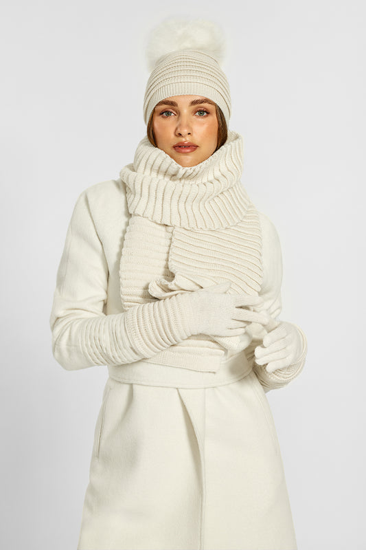 Sentaler Adult Ribbed Gloves, Ribbed Hat with Oversized Fur Pompon and Ribbed Gloves crafted in Baby Alpaca and in Ivory. Seen from front on model.