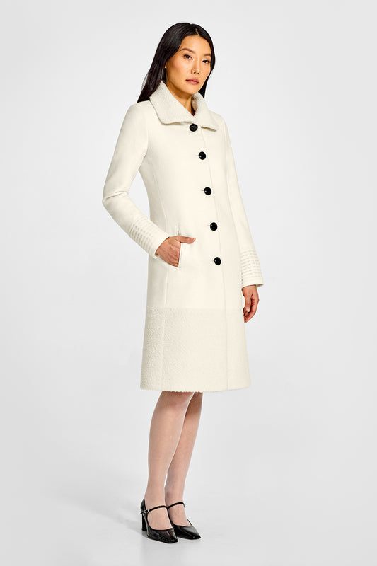 Sentaler A-line Ivory Coat with Bouclé Alpaca Collar and Trim in Baby Alpaca wool. Seen from side on female model.