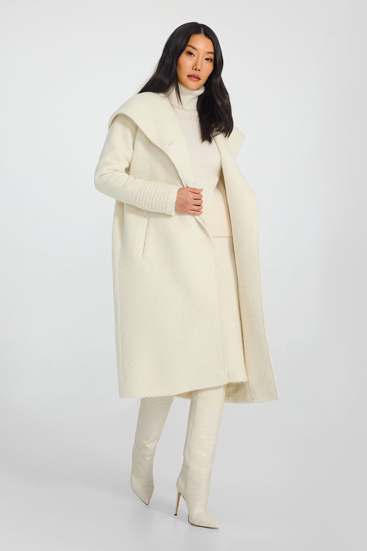 Sentaler Bouclé Alpaca Long Hooded Ivory Coat in Bouclé Alpaca wool. Seen from side open on female model.