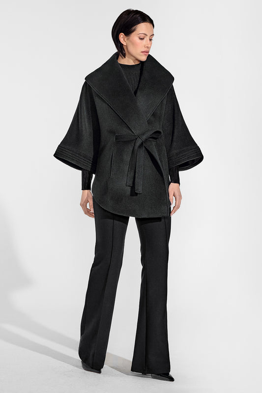 Sentaler Cape with Shawl Collar and Belt featured in Baby Alpaca and available in Black. Seen from front on female model who is wearing the coat belted.