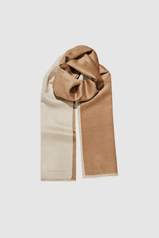 Sentaler Double Sided Suri Alpaca Scarf featured in Suri Alpaca and available in Dark Camel-Light Taupe. Seen as off figure wrapped.