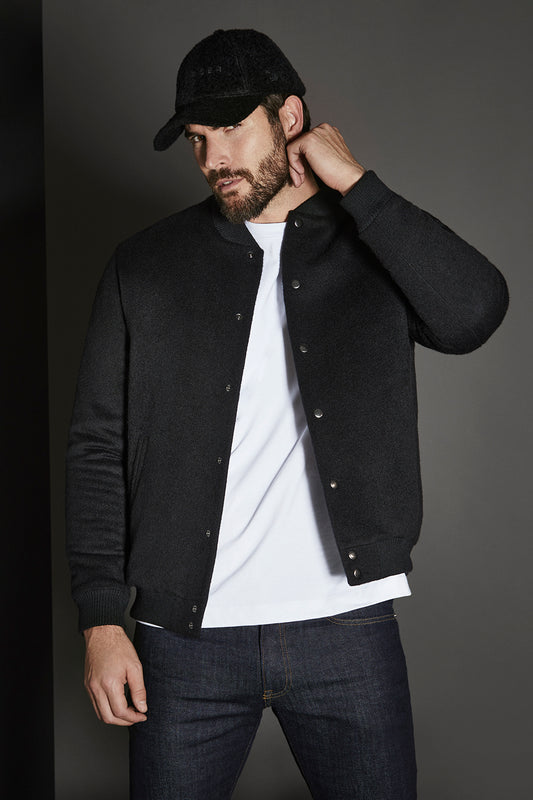 Sentaler Baby Alpaca Varsity Black Jacket in Technical Baby Alpaca wool. Seen from front open above the knees on male model.