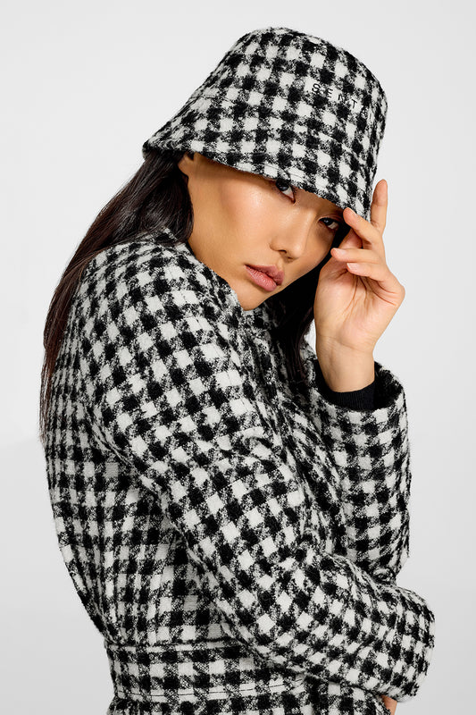 Sentaler Tweed Black and White Houndstooth Bucket Hat in Tweed Suri Alpaca wool. Seen from side close up on female model.
