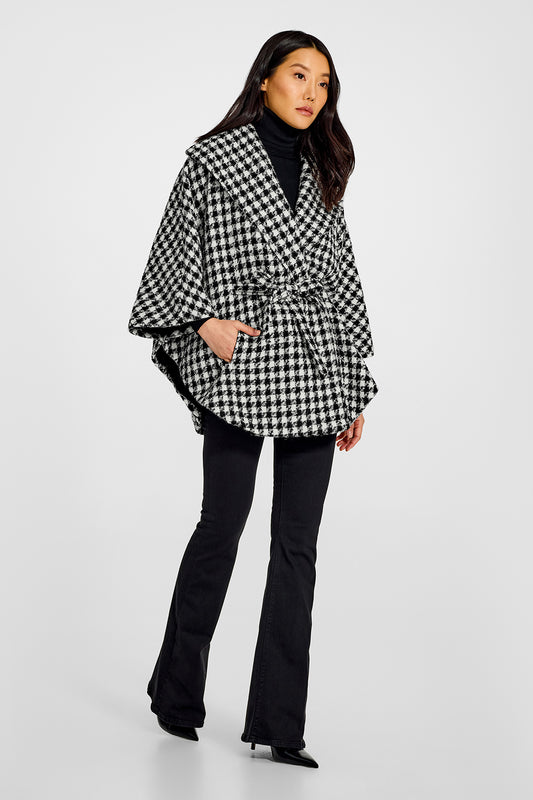 Sentaler Tweed Black and White Houndstooth Cape in Tweed Suri Alpaca wool. Seen from side belted on female model.