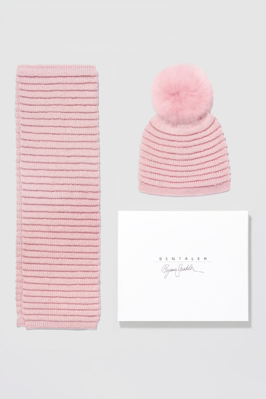 Sentaler Kids (1-5 Years) Ribbed Scarf and Ribbed Hat with Oversized Fur Pompon featured in Baby Alpaca and available in Pink. Seen as off figures.