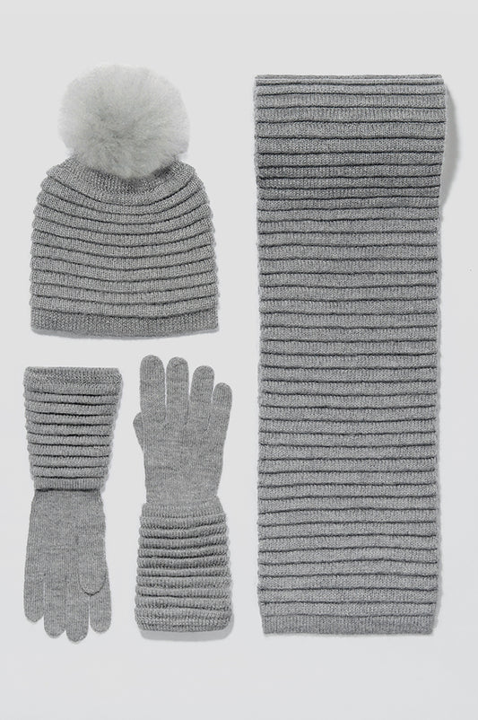 Sentaler Adult Ribbed Hat With Oversized Fur Pompon featured in Baby Alpaca and available in Grey. Seen with scarf and gloves off model.