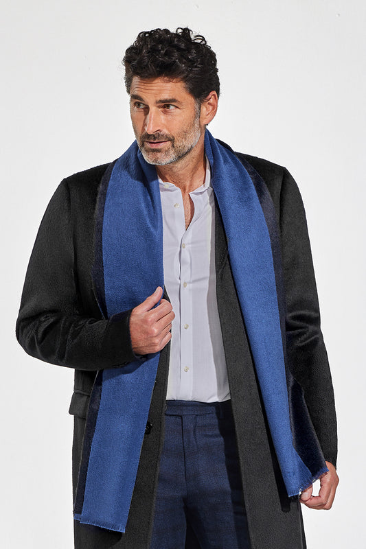 Sentaler Double Sided Suri Alpaca Scarf featured in Suri Alpaca and available in Black-Blue. Seen from front above the knees on model.