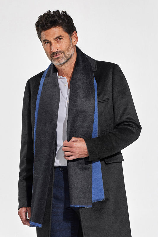 Sentaler Double Sided Suri Alpaca Scarf featured in Suri Alpaca and available in Black-Blue. Seen from front above the knees on model.