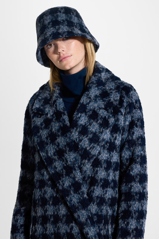 Sentaler Houndstooth Suri Alpaca Bucket Hat featured in Suri Alpaca and available in Navy Houndstooth. Seen from front close up on model.