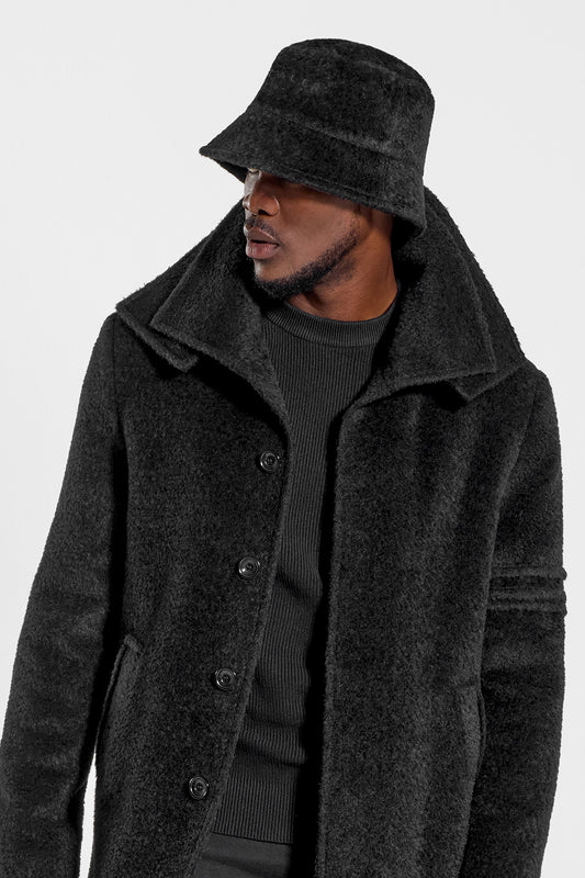 Sentaler Mens Bouclé Alpaca Bucket Hat featured in Bouclé Alpaca and available in Black. Seen from side close up on model.