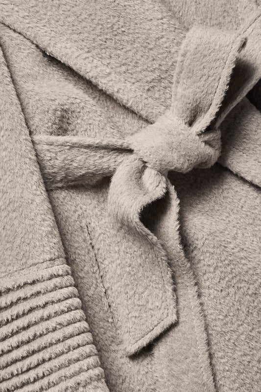 Sentaler Bouclé Alpaca Long Notched Collar Wrap Coat featured in Bouclé Alpaca and available in Sand. Seen fabric up close of tie.